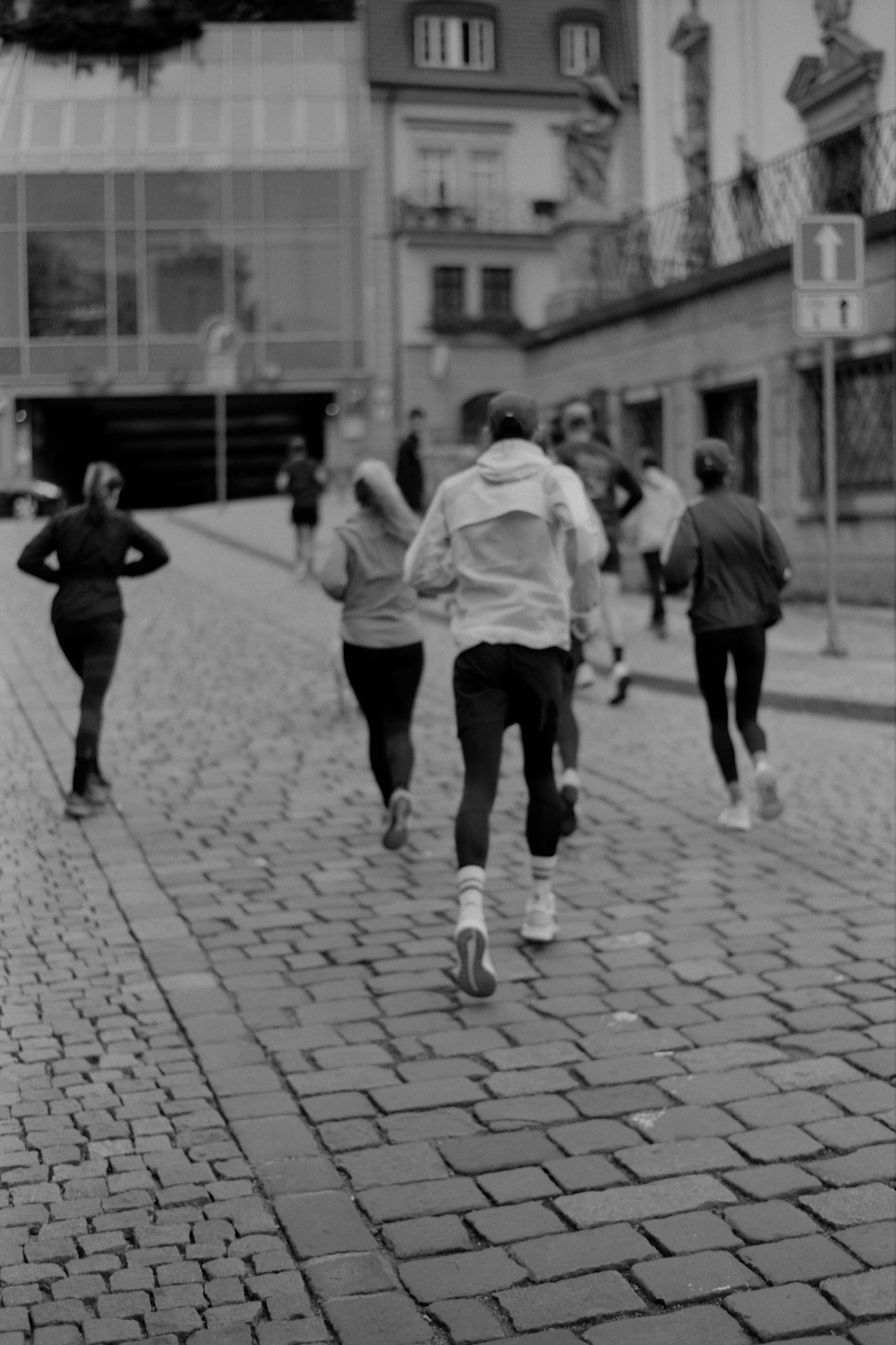 Runners together on cobblestone street